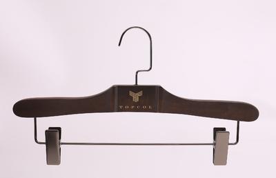 Dark brown wooden hanger with clips for clothes shop